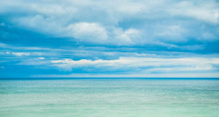 Sea, horizon and clouds in the sky.の写真素材