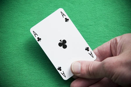 A Colouful Photo of Someone Dealing an Ace Playing Cardの写真素材