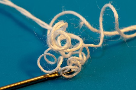 Thread a needle.  Metal and steel. Extremely macroの写真素材