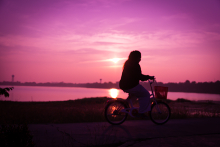 Blurry silhouette of friends on bicycle for exercise.の写真素材