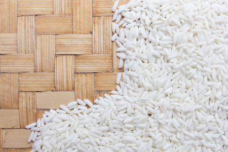 Close up rice grain on wooden basket.の写真素材