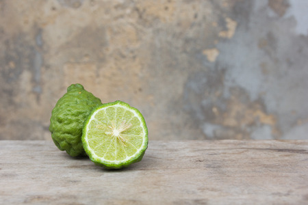 kaffir lime fruits on wood background.