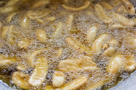 Fried banana dessert in hot oil.の写真素材
