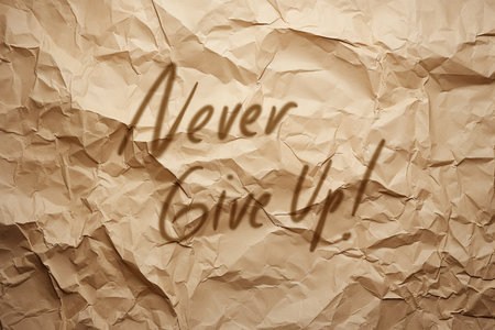 Generative AI Image of Vintage Brown Crumpled Paper with Words of Motivationの素材