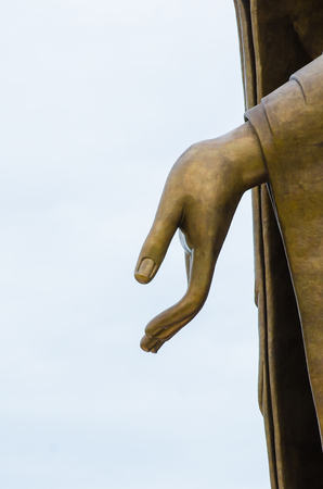 Statue hand of buddha on sky background の写真素材