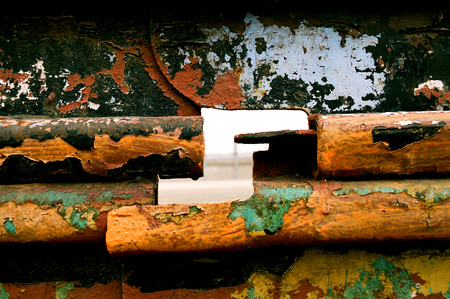 USA, Mexico border fence, looking through hole on Mexican side towards USの写真素材