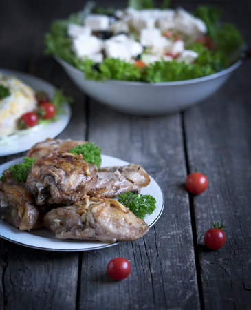 meat, greek salad, salad with mushrooms and tomatoes on a wooden backgroundの写真素材