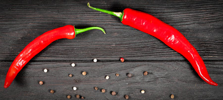 Hot red pepper on sacking and an old blackboard