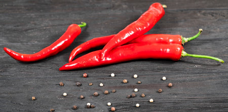 Hot red pepper on sacking and an old blackboard