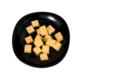 cheese cubes in a plate on a white backgroundの写真素材