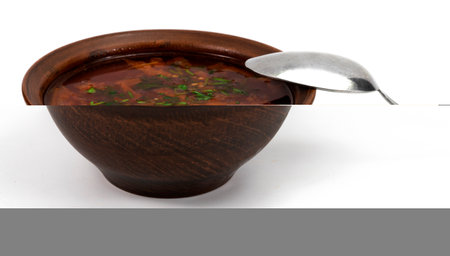 The bowl of red borsch with sour cream