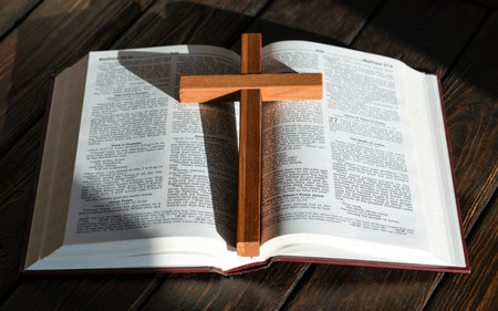wooden cross and bible on wooden backgroundの写真素材