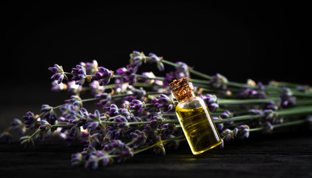 oil and lavender bouquet on black wooden backgroundの写真素材
