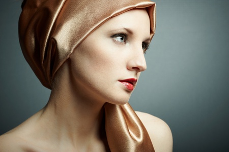 Portrait of the young girl with golden scarf on headの写真素材