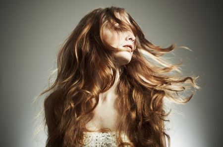 Portrait of the beautiful woman with red curly hairの写真素材