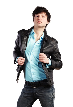 Closeup portrait of the beautiful young sexual man in a leather jacket, on a white backgroundの写真素材