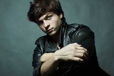 Fashion portrait of the young sexual man in studioの写真素材