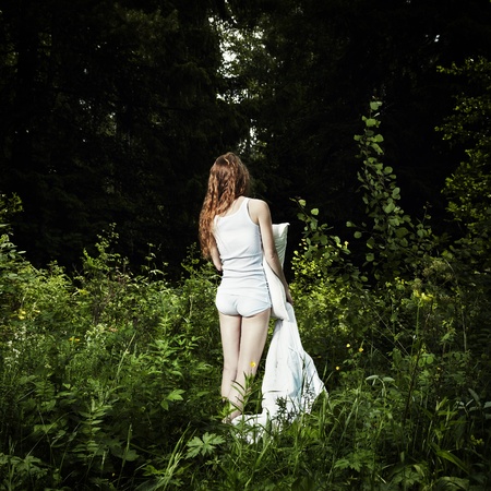 Portrait of the young woman in mysterious woodの写真素材