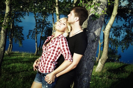 Portrait of love couple embracing outdoor in parkの写真素材