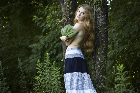 Portrait of romantic woman at the green forestの写真素材