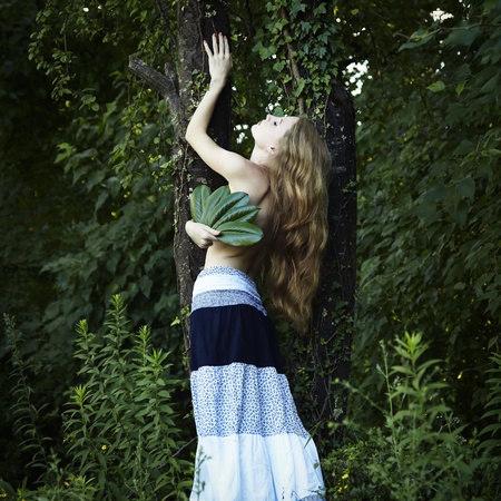 Portrait of romantic woman at the green forestの写真素材