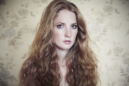 Photo of young beautiful woman with red curly hairの写真素材