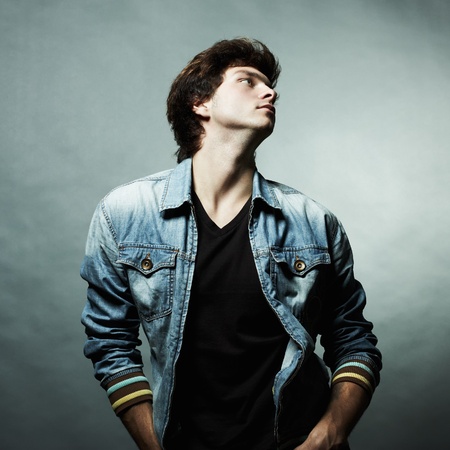 Fashion portrait of the young beautiful man in studioの写真素材