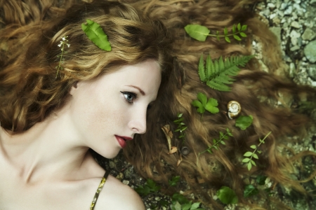 Fashion portrait of young sensual woman in gardenの写真素材
