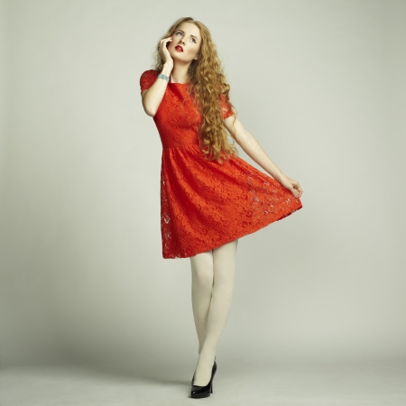 Fashion photo of young magnificent woman in red dress.の写真素材