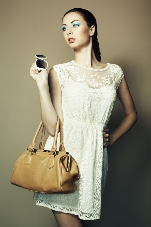 Portrait of beautiful young woman with a leather bag  の写真素材