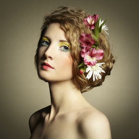 Beautiful young woman with delicate flowers in their hair. Spring photosの写真素材
