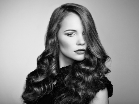 Portrait young beautiful woman with curly hair. Fashion photoの写真素材