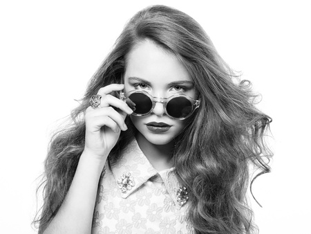 Portrait of beautiful woman in sunglasses on white background  Fashion photoの写真素材