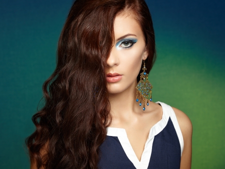 Portrait of beautiful brunette woman with earring. Perfect makeup. Fashion photoの写真素材