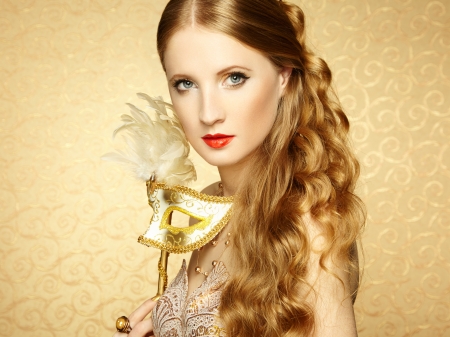 Beautiful young woman in mysterious golden Venetian mask. Fashion photoの写真素材
