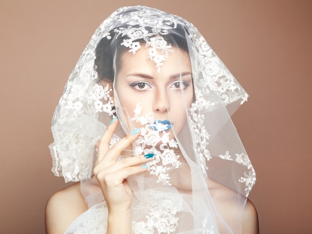 Fashion photo of beautiful women under white veilの写真素材