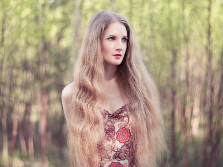 Beautiful young woman in summer garden. Beauty summertimeの写真素材