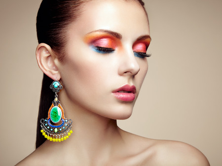 Portrait of beautiful young woman with earring  Jewelry and accessories  Perfect makeup  Fashion photoの写真素材