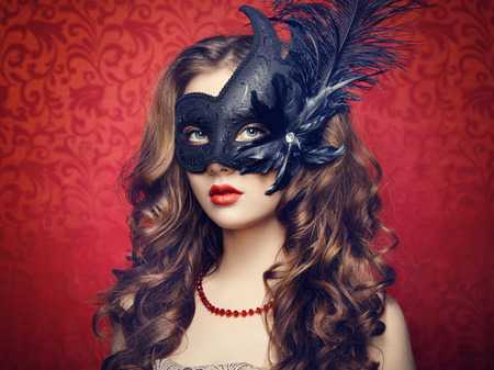 Beautiful young woman in black mysterious  Venetian mask  Fashion photoの写真素材
