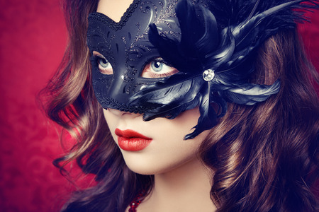 Beautiful young woman in black mysterious  Venetian mask  Fashion photoの写真素材