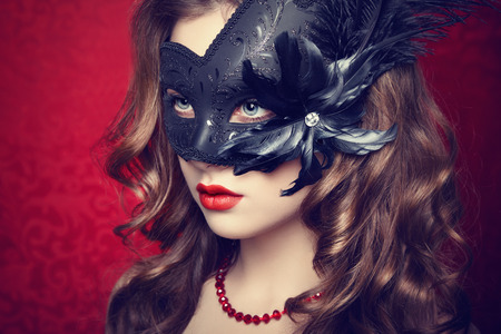 Beautiful young woman in black mysterious  Venetian mask  Fashion photoの写真素材