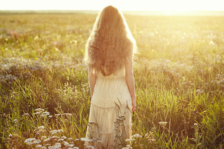 Young beautiful girl on a summer field  Beauty summertime  Fashion photoの写真素材
