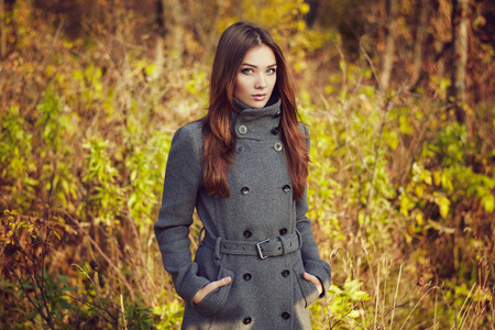 Portrait of young beautiful woman in autumn coat. Fashion photoの写真素材