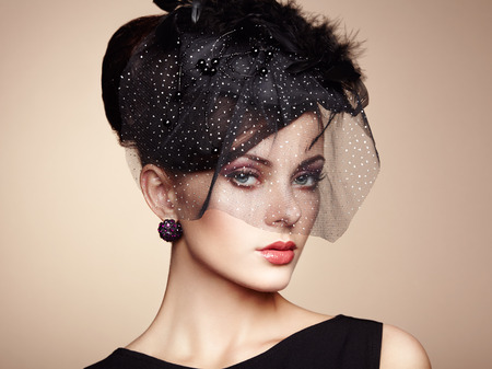 Retro portrait of a beautiful woman. Vintage style. Perfect make-up. Fashion photoの写真素材