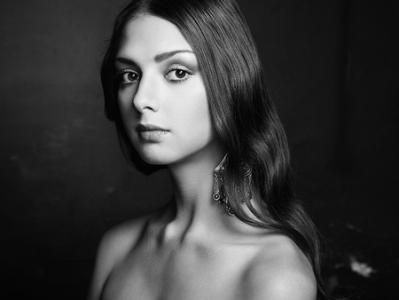 Portrait of beautiful young woman with earring. Fashion photoの写真素材