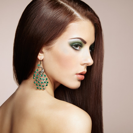 Portrait of beautiful brunette woman with earring. Perfect makeup. Fashion photoの写真素材