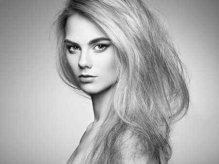 Fashion portrait of elegant woman with magnificent hair. Blonde girl. Perfect make-up. Hairstyle