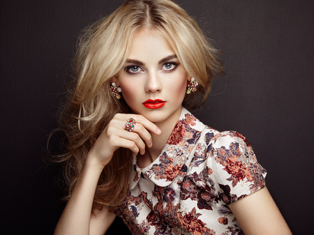 Portrait of beautiful sensual woman with elegant hairstyle. Perfect makeup. Blonde girl. Fashion photo. Jewelry and dress Portrait of beautiful sensual woman with elegant hairstyle. Perfect makeup. Blonde girl. Fashion photo. Jewelry and dress
