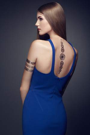 Fashion portrait of elegant woman with magnificent hair. blonde girl. Perfect make-up. Girl in elegant dress. Flash tattoo goldの写真素材