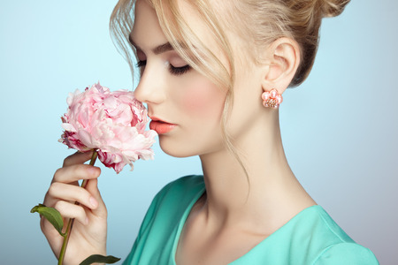 Portrait of beautiful sensual woman with elegant hairstyle.  Perfect makeup. Blonde girl. Fashion photo. Flowersの写真素材